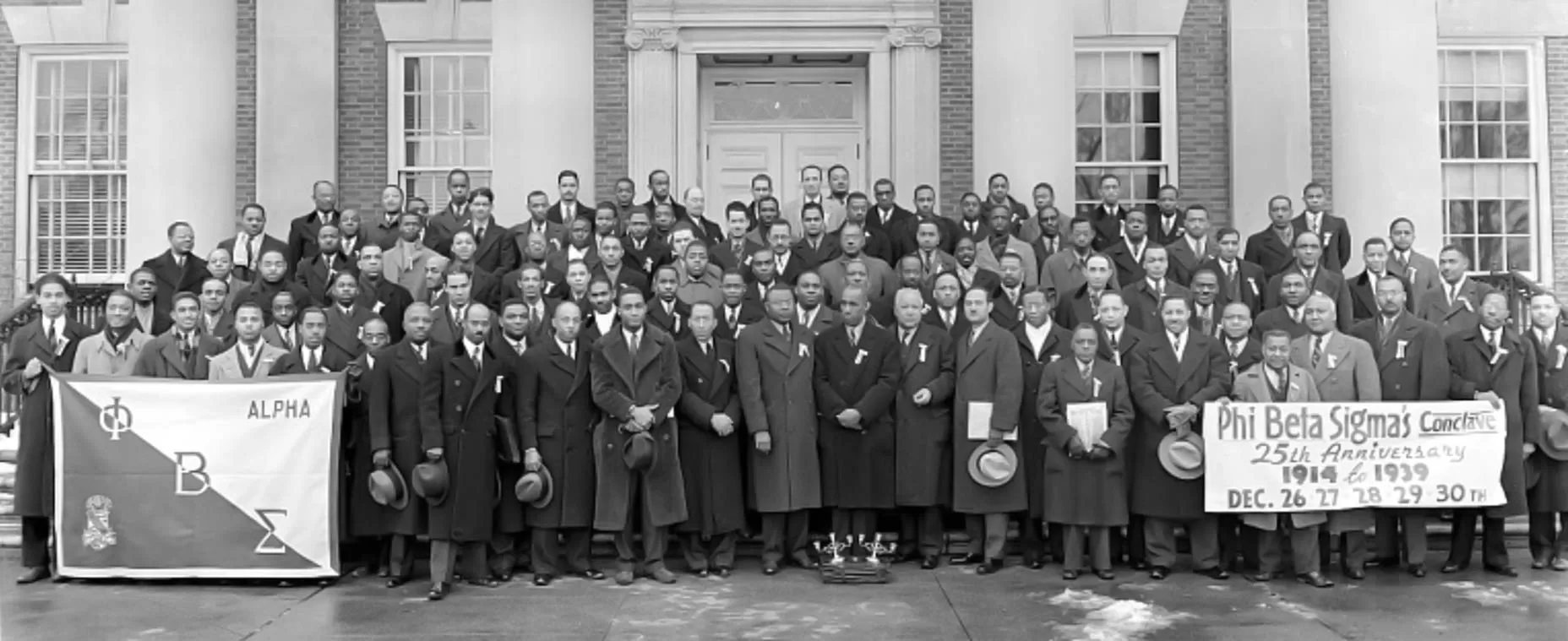 General Fraternity President Jonathan Brant, Miami '75, and three South Florida brothers stand beside the Zeta Beta Chapter's charter.